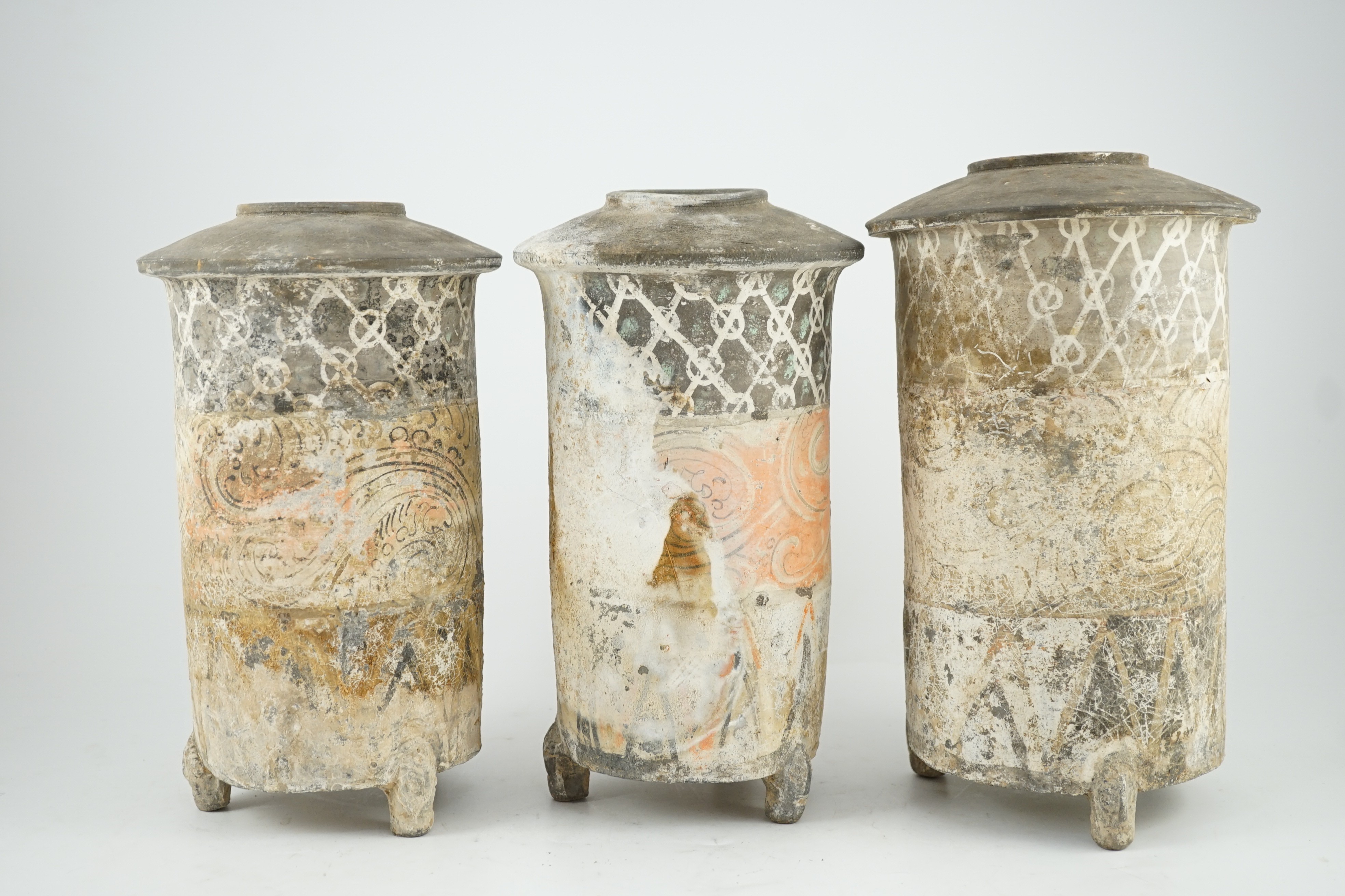 Three Chinese pigment painted grey pottery ‘granary’ jars, Han dynasty (200BCE - 220CE), 29.5 and 32cm high